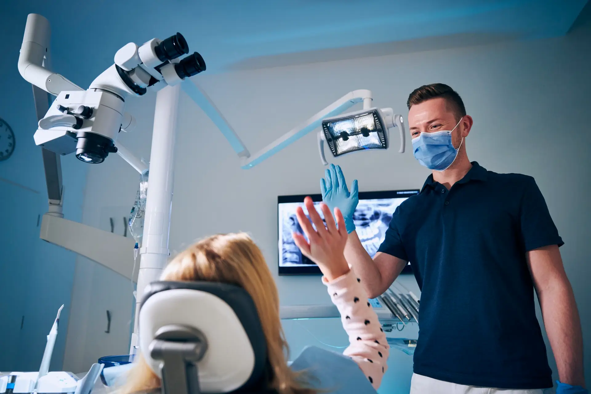 Dentist giving high-five to patient
