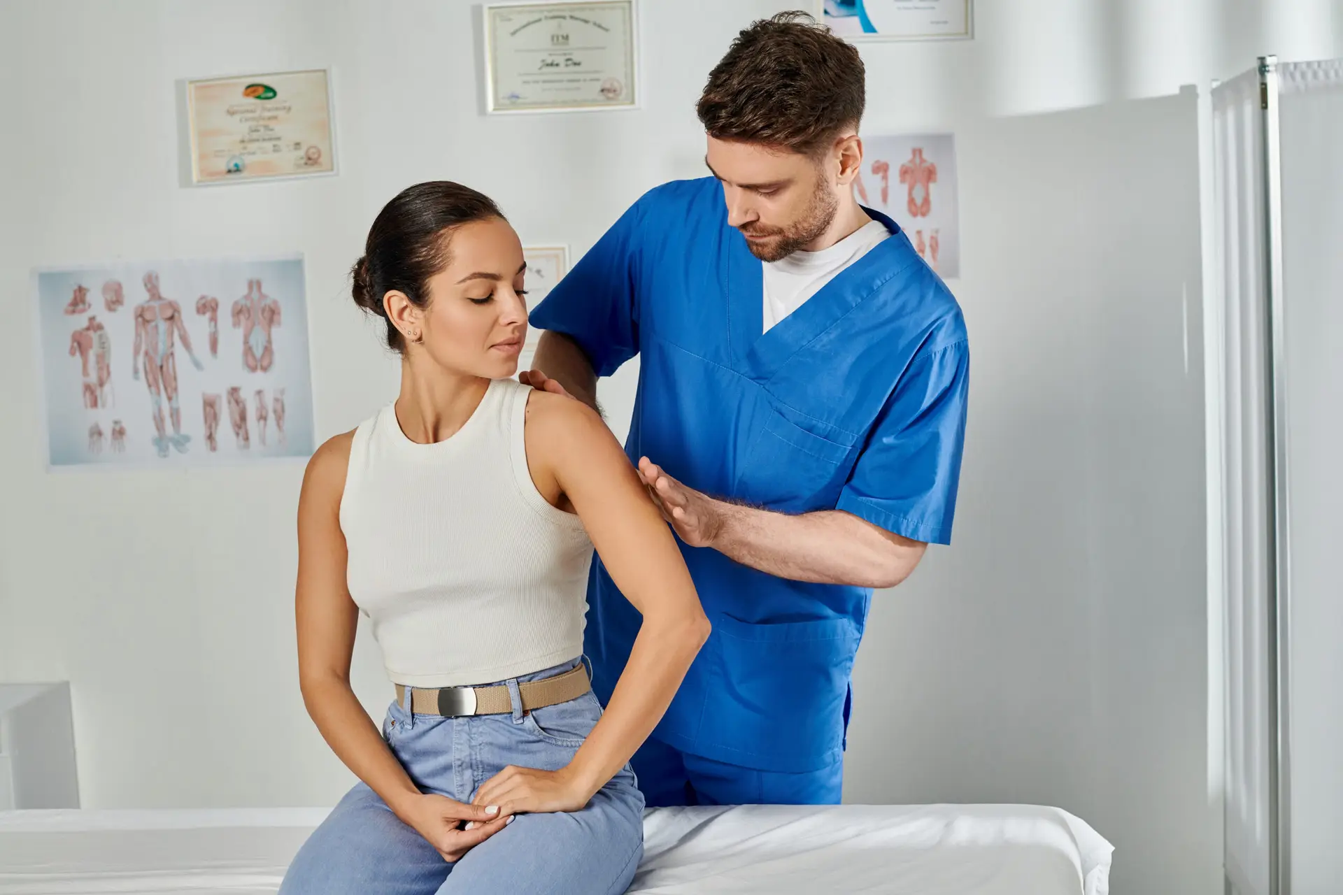 Doctor massaging patient's shoulder