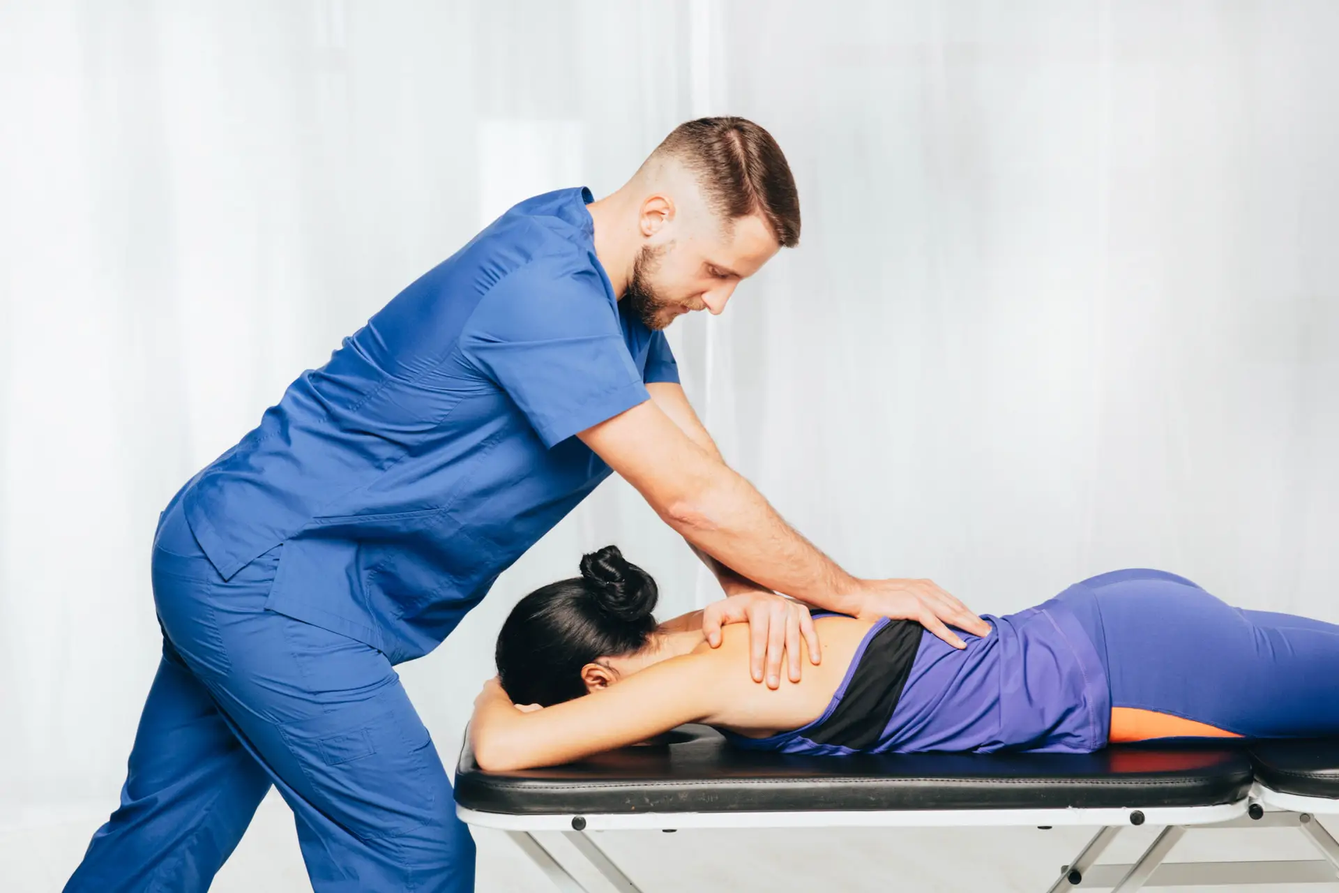 Physiotherapist giving back massage