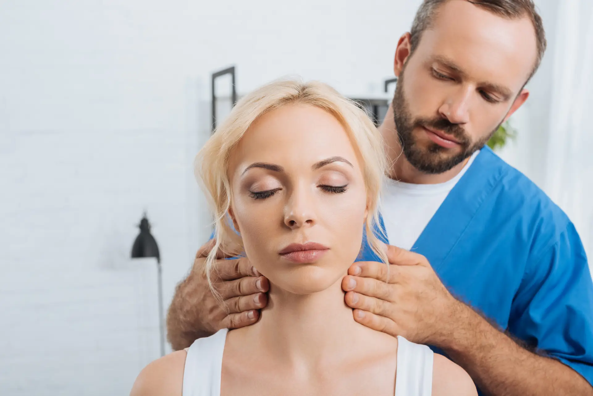 Massage therapist treating neck pain