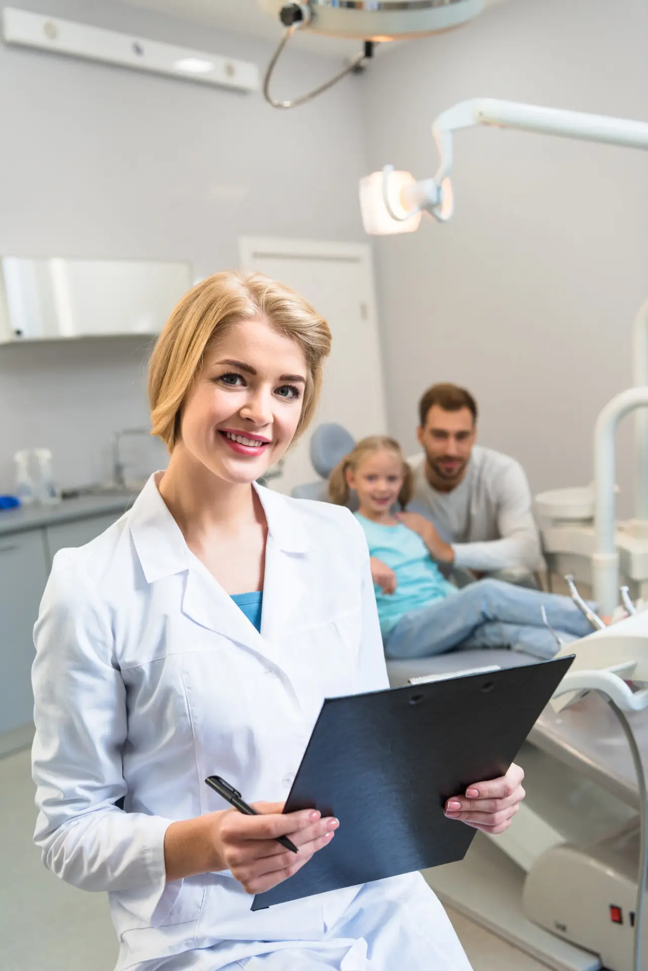 Female dentist with clipboard smiling