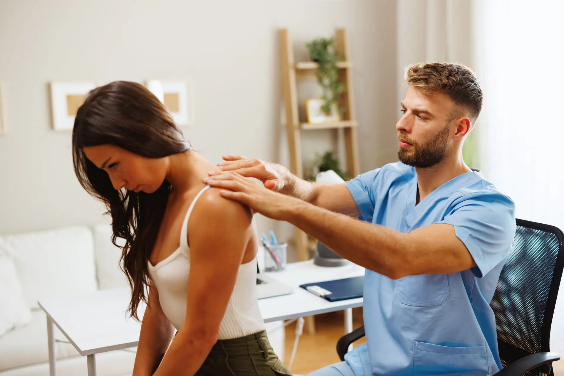 Chiropractor examining woman's neck